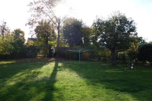 a shadow of a windmill in a grass yard at Ferienwohnung "Meißner" in Rechlin
