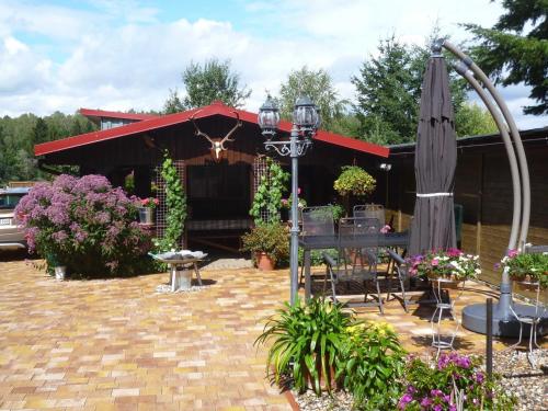 a patio with an umbrella and a table and chairs at Ferienwohnung Petra Bargel "die Nr 1"in Speck in Speck