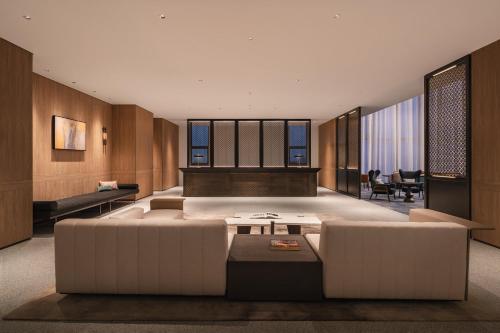 a living room with a couch and a table at Crowne Plaza Penang Straits City by IHG in Perai