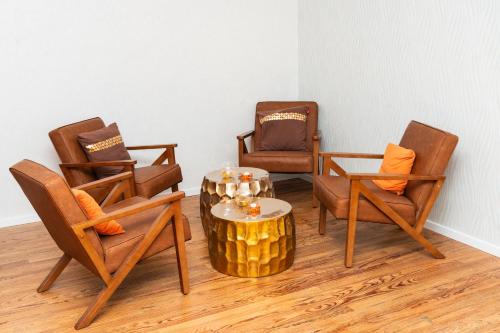 a living room with three chairs and a table with a coffee table at Hotel Phoenix in Berghausen