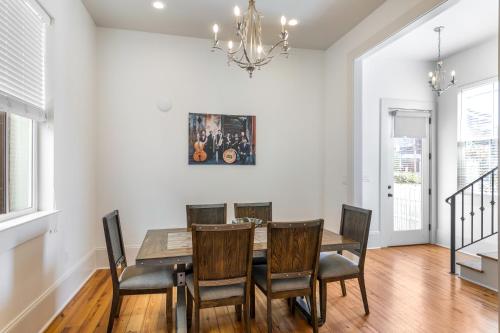 a dining room with a table and chairs and a chandelier at Spacious 3BR Garden District Home w Pool & Balcony in New Orleans