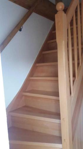 a staircase in a house with a wooden railing at Gästehaus Alte Schule in Buschhof
