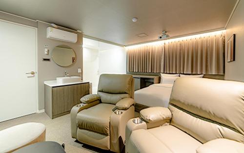 a hotel room with a bed and a sink at Aank Hotel Incheon Bupyeong in Incheon