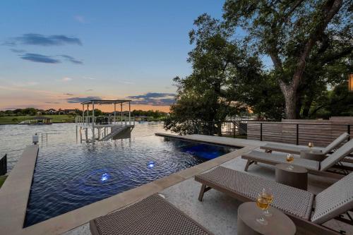 a swimming pool with a picnic table and a playground at Ellen Lake Luxe with Concierge Services in Kingsland