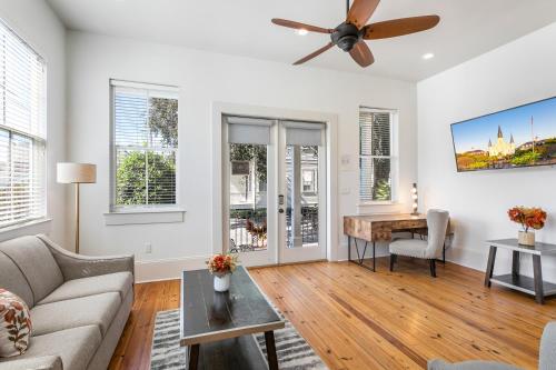 a living room with a couch and a table at Fabulous Cottages with City Views in New Orleans