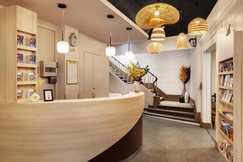 a lobby of a store with a counter and stairs at Grand Hôtel Lille in Lille