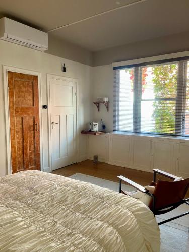 a bedroom with a bed and a large window at Huis Hector Mechiels ROOM in Sint-Niklaas