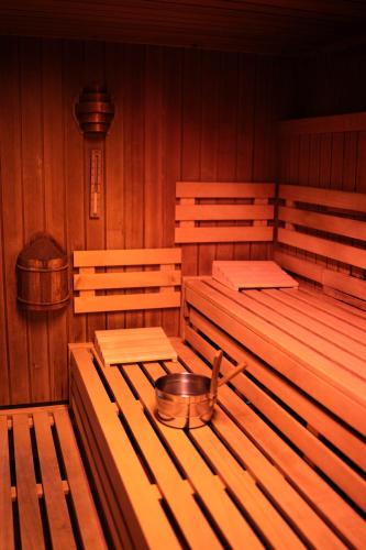 a empty room with wooden benches and a bowl on the table at Terrassenhaus Waldblick 637 in Hohegeiß