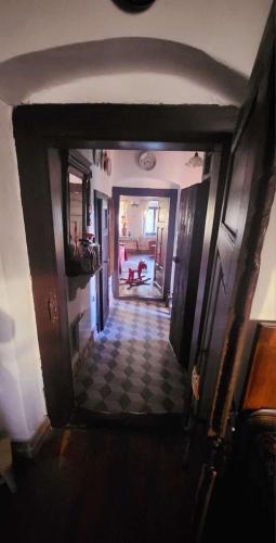 a hallway of a house with a checkered floor at Main Road Seven Vendégház in Füzérradvány