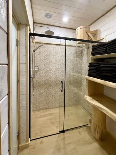 a shower with a glass door in a bathroom at Ośrodek Wczasów Zdrowotnych Rudawka Rymanowska in Rudawka Rymanowska