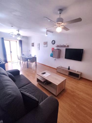 a living room with a couch and a table at Swieqi 3 bedroom apartment in St. Julianʼs