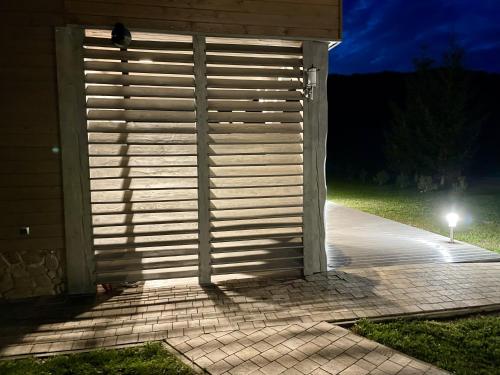 a door to a building at night with a light at Ośrodek Wczasów Zdrowotnych Rudawka Rymanowska in Rudawka Rymanowska