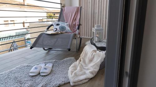 a room with a chair and a towel and a rug at La Casa Di Marty Per 9 - Belcantovillas in Torre del Lago Puccini