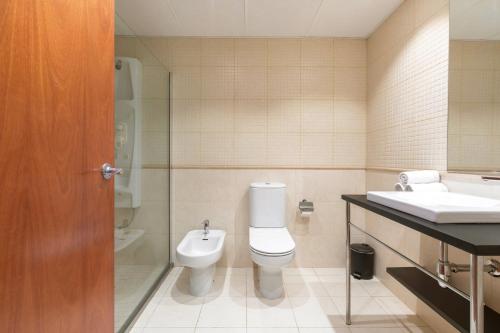 a bathroom with a toilet and a sink at Acta Sant Just in Sant Just Desvern