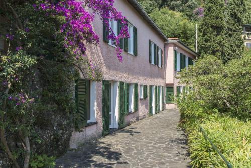 a house with purple flowers on the side of it at Villa Peninsula in Portofino