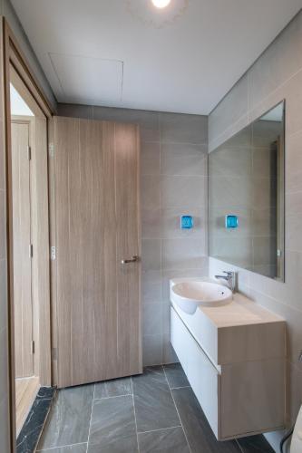 a bathroom with a sink and a mirror at 2BR 69m2 Beautiful view at Vinhomes Grand Park in Gò Công