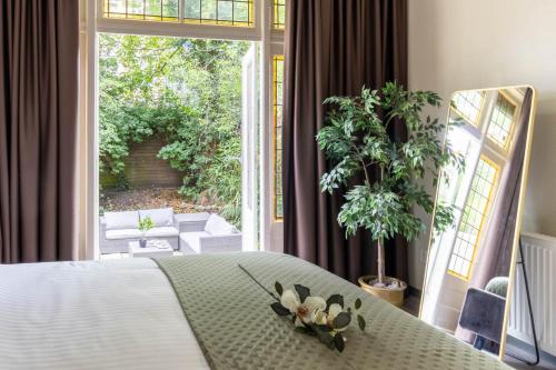 a bedroom with a bed and a large window at Rotterdam City Loft Delfshaven in Spangen