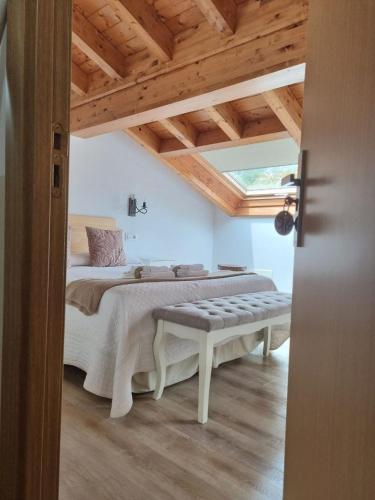 a bedroom with a large bed and a wooden ceiling at El Rincon del Cuera in Parres de Llanes