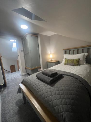 a bedroom with a bed with two towels on it at The Tweed in the centre of Melrose in Melrose