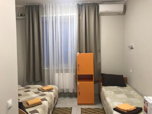a room with two beds and an orange cabinet at Karavella in Mykolaiv