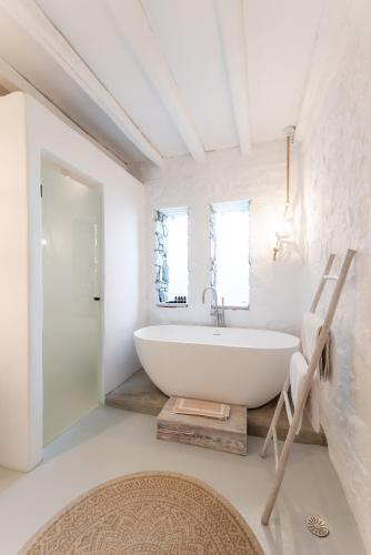 a bathroom with a large white tub and a ladder at Villa Alice in Elia Beach