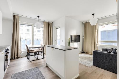 a living room with a couch and a table at Kotimaailma Apartments Pukkila II in Turku