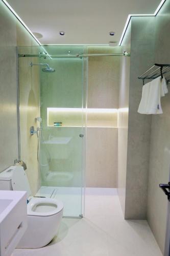 a bathroom with a glass shower and a toilet at RIO Hotel in Samarkand
