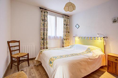 une chambre avec un lit, une chaise et une fenêtre dans l'établissement EdenWeiss - Appt 6p à 1km des pistes, aux Angles