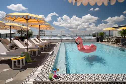 a swimming pool with a pink flamingo in the water at Moxy St. Petersburg Downtown in St. Petersburg