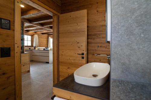 a bathroom with a white sink on a counter at Chalet Schafberg in Wildhaus