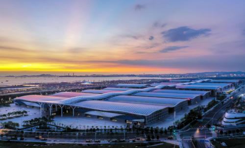 a building with blue roofs with a sunset in the background at InterContinental Shenzhen WECC by IHG in Shenzhen