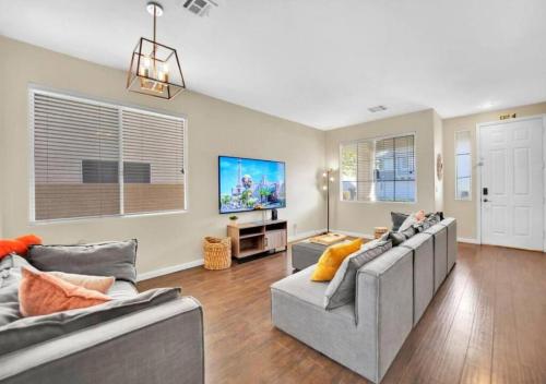 a living room with two couches and a tv at Seven Palms in Henderson