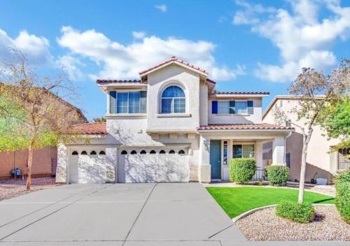 a large white house with a driveway at Seven Palms in Henderson