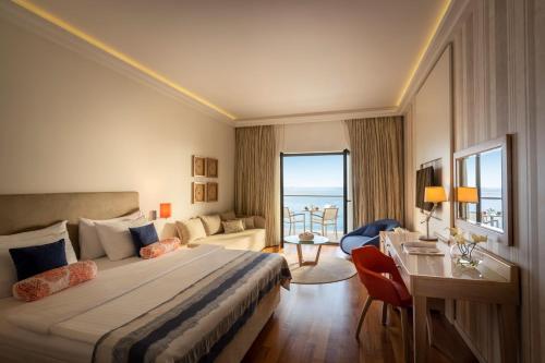 a hotel room with a large bed and a desk at Isabella Island Resort, Valamar Collection in Poreč