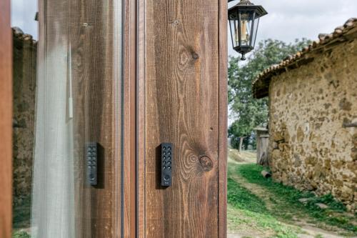a wooden door with a window and a lamp at La Cabanya de La Rovira in Joanetes