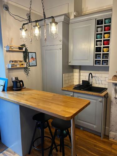 a kitchen with a wooden counter top in a room at Studio 77 - Stylish, Free Parking, Fast Wi-Fi, Netflix in Sheffield