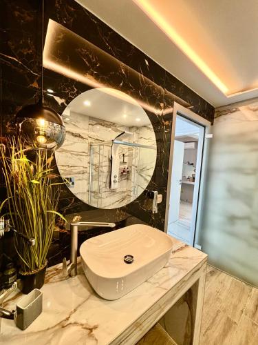 a bathroom with a white toilet and a mirror at Candi Luxury Suites 2 in Neos Marmaras
