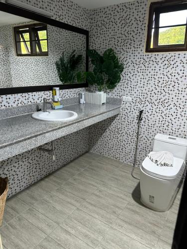a bathroom with a sink and a toilet at Beverly Hills Villa Patong in Patong Beach