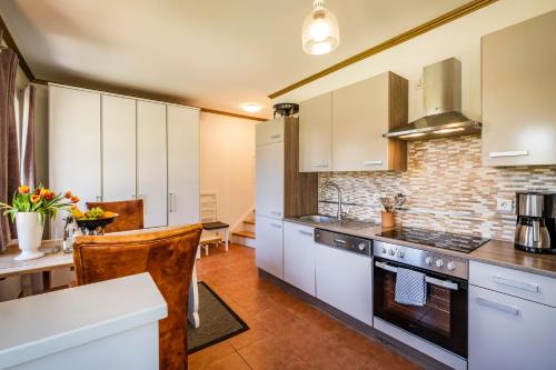 a kitchen with white cabinets and a counter top at Seehotel Lichtenberg in Lichtenberg