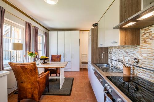 a kitchen with a table and a dining room at Seehotel Lichtenberg in Lichtenberg