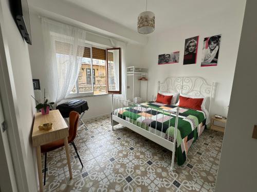 a bedroom with a bed and a table and a desk at Edahouse in Salerno