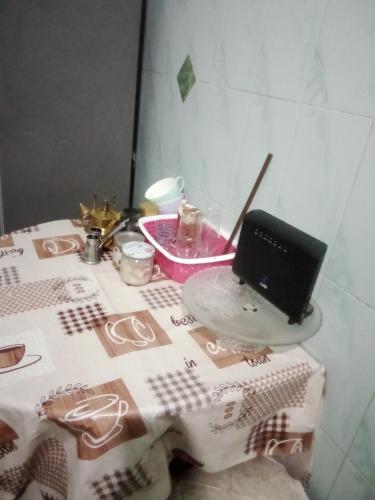 a table with a table cloth with a laptop on it at Nubian Life Nile View in Aswan