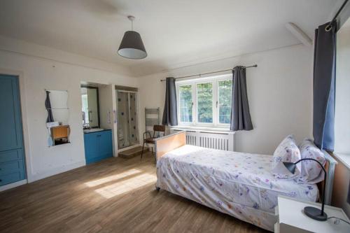a bedroom with a bed and a desk and a window at Canford house on Westbury on Trym in Bristol