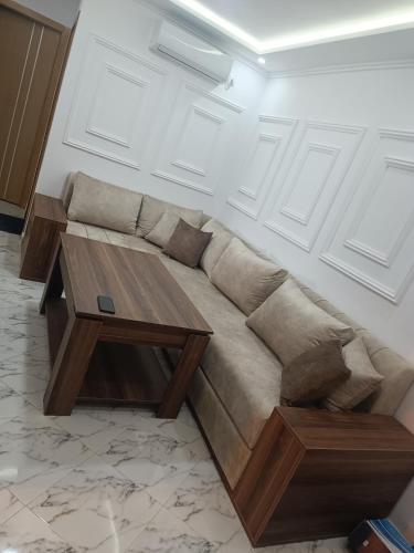 a living room with a couch and a table at plage Taït club omeGa in Andalouciene
