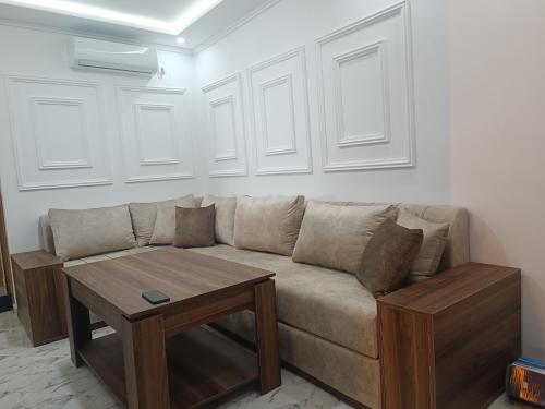 a living room with a couch and a table at plage Taït club omeGa in Andalouciene
