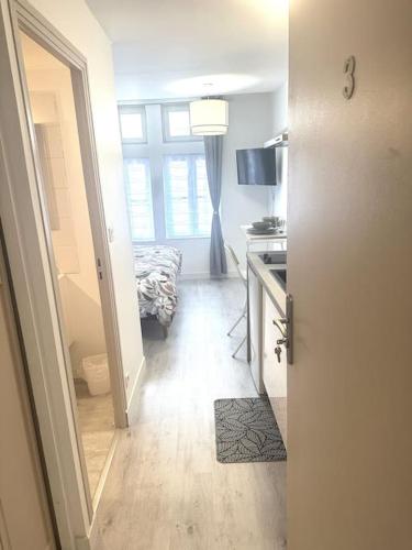 - un couloir avec une porte menant à une chambre avec un lit dans l'établissement Résidence Champenoise 3, Troyes - France, à Troyes