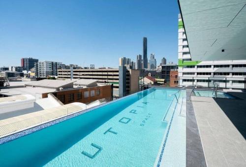 a large swimming pool on the roof of a building at Utopia City Oasis Exquisite Urban Retreat in Brisbane
