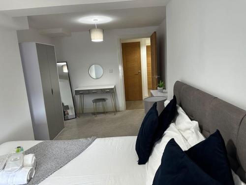 a bedroom with a bed with blue pillows at 1 bed spacious flat in Essex in Brentwood