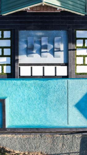 an overhead view of a swimming pool with pillows at Silk Cotton Cottages in Parrot Hall