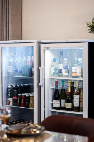 an open refrigerator filled with bottles of water and drinks at Dacha in Astana